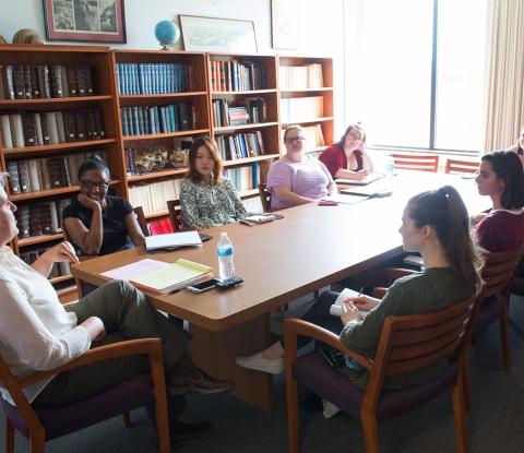 Languages class discussing at a table